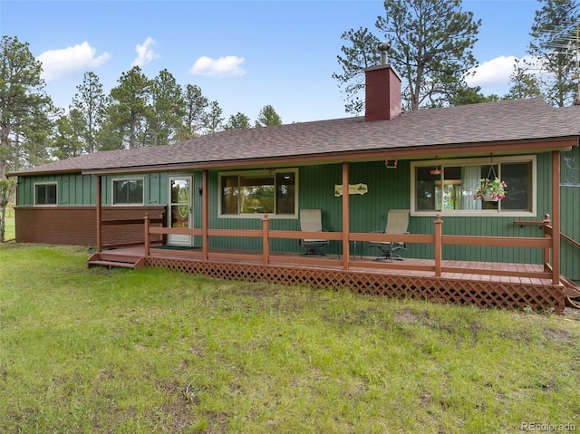 13365 Meadow Glen Ln, Colorado Springs, CO 80908 - rear view of house with a chimney, a shingled roof, and a yard