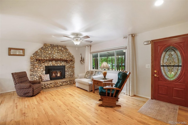 13365 Meadow Glen Ln, Colorado Springs, CO 80908 - living room with wood finished floors, a ceiling fan, and a fireplace
