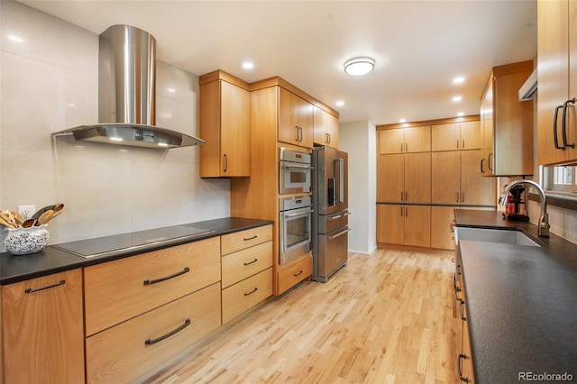 13365 Meadow Glen Ln, Colorado Springs, CO 80908 - kitchen with wall chimney range hood, appliances with stainless steel finishes, dark countertops, light wood-type flooring, and backsplash
