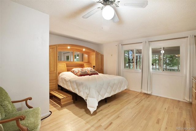 13365 Meadow Glen Ln, Colorado Springs, CO 80908 - bedroom with light wood-style floors, a ceiling fan, and arched walkways