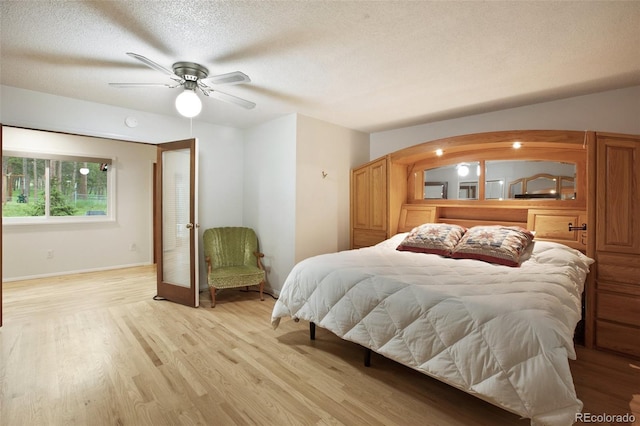 13365 Meadow Glen Ln, Colorado Springs, CO 80908 - bedroom featuring light wood-style floors, a textured ceiling, and a ceiling fan