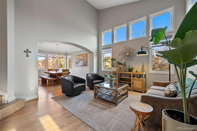 living room with a chandelier and light hardwood / wood-style flooring