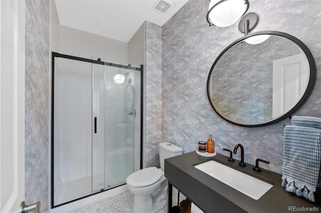 bathroom with tile patterned flooring, toilet, a shower with shower door, and sink