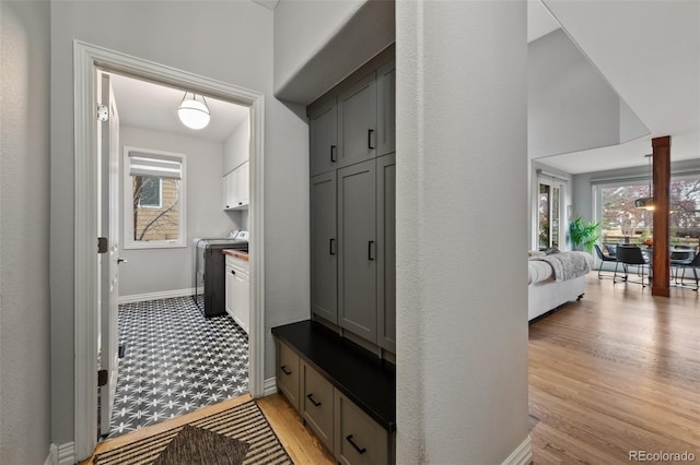 mudroom with washer / dryer and light wood-type flooring