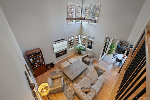 living room featuring wood-type flooring and a high ceiling