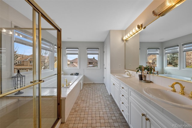 bathroom with tile patterned floors, separate shower and tub, and vanity