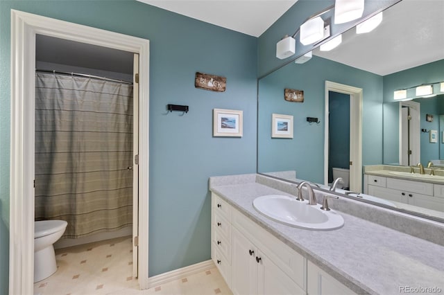 bathroom with vanity, a shower with shower curtain, and toilet