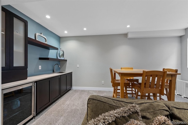 carpeted dining area featuring radiator heating unit, wine cooler, and indoor wet bar