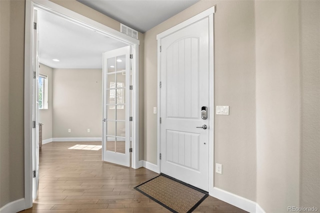 foyer entrance featuring wood-type flooring