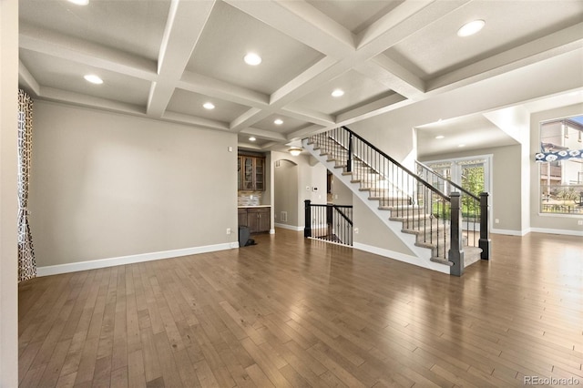 unfurnished living room with coffered ceiling, beamed ceiling, and dark hardwood / wood-style floors