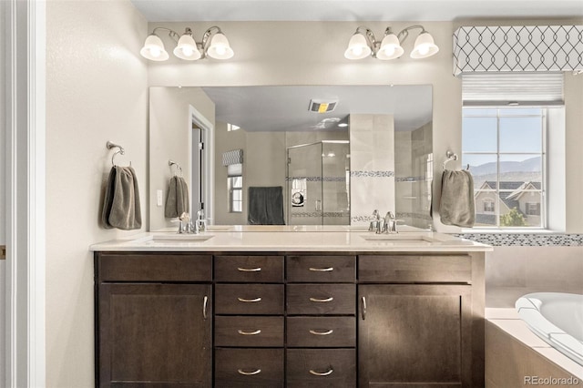 bathroom featuring vanity and separate shower and tub