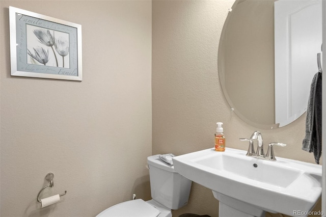 bathroom featuring sink and toilet