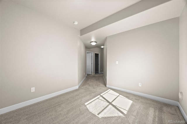 spare room featuring light colored carpet