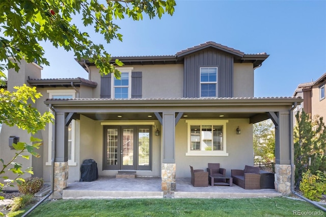 back of house featuring an outdoor living space and covered porch