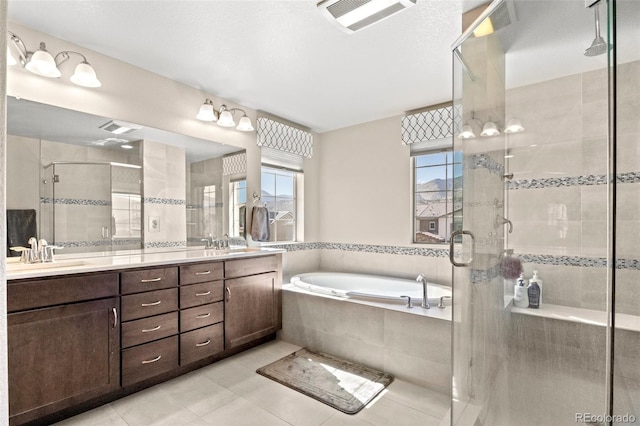 bathroom featuring tile patterned floors, vanity, and separate shower and tub