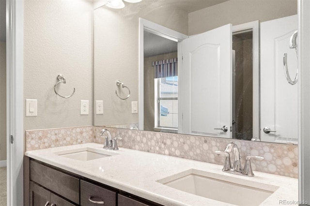 bathroom with decorative backsplash and vanity