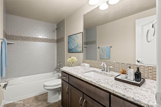 full bathroom with tasteful backsplash, vanity, toilet, and tiled shower / bath