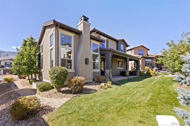 rear view of house featuring a yard