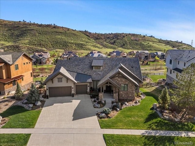 15116 Lyons Ridge Dr, Morrison, CO 80465 - view of front of house featuring fence, concrete driveway, a front yard, and a residential view