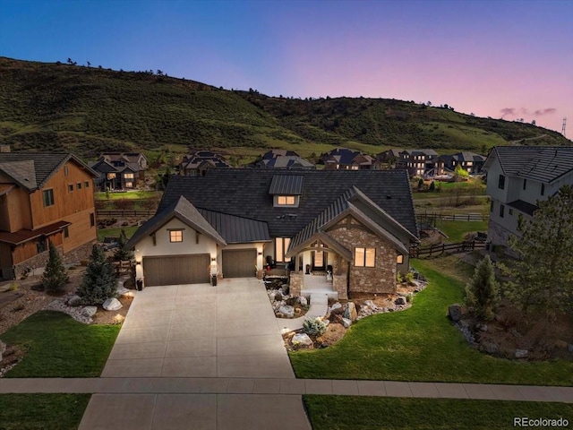 15116 Lyons Ridge Dr, Morrison, CO 80465 - view of front of house with fence, a residential view, an attached garage, a yard, and driveway
