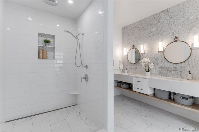 15116 Lyons Ridge Dr, Morrison, CO 80465 - bathroom featuring vanity, marble finish floor, a tile shower, and tasteful backsplash