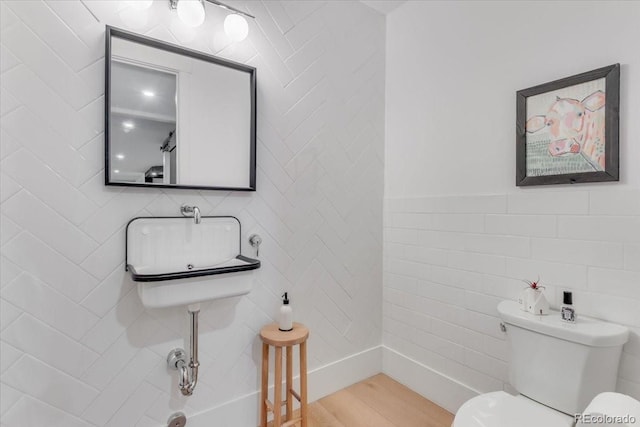 15116 Lyons Ridge Dr, Morrison, CO 80465 - bathroom with wood finished floors, toilet, and tile walls