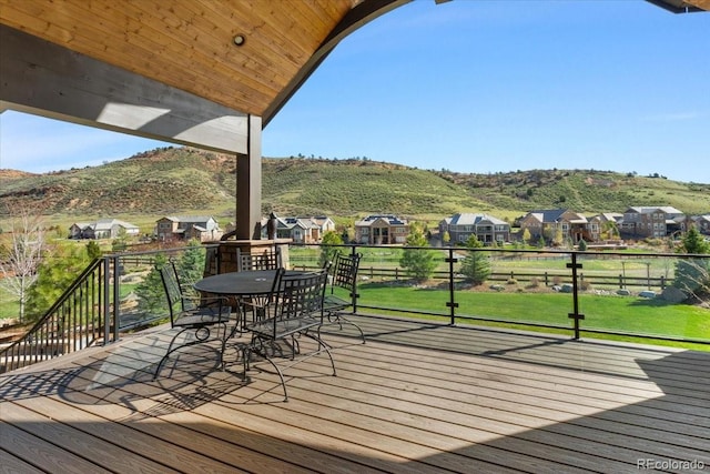 15116 Lyons Ridge Dr, Morrison, CO 80465 - wooden deck featuring a mountain view, a yard, a residential view, and outdoor dining space