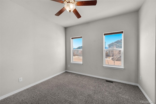 carpeted spare room with ceiling fan