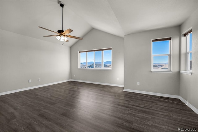 spare room with lofted ceiling, a wealth of natural light, ceiling fan, and dark hardwood / wood-style floors