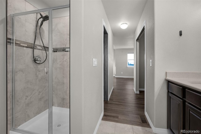 bathroom featuring vanity and an enclosed shower