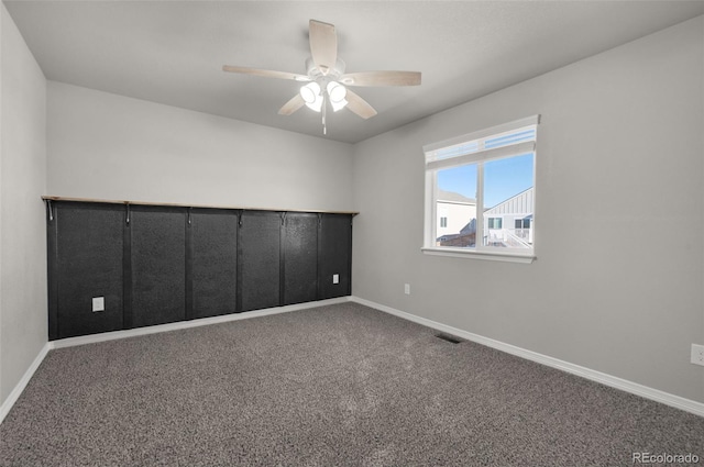 spare room featuring carpet and ceiling fan