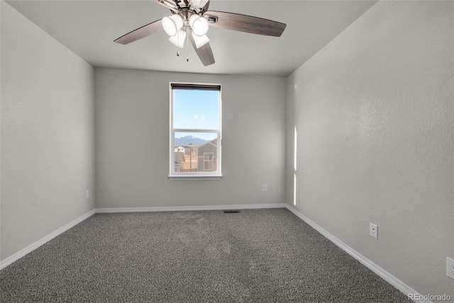 empty room with carpet flooring and ceiling fan