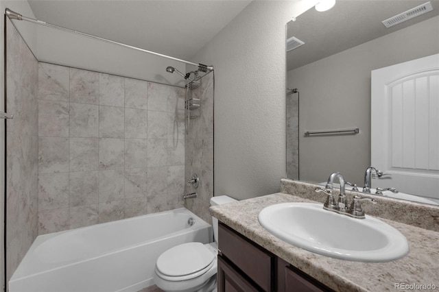 full bathroom featuring vanity, toilet, and tiled shower / bath