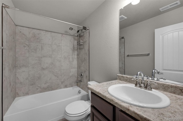 6677 Lamine Dr, Colorado Springs, CO 80925 - full bathroom featuring visible vents, toilet, vanity, and a textured wall