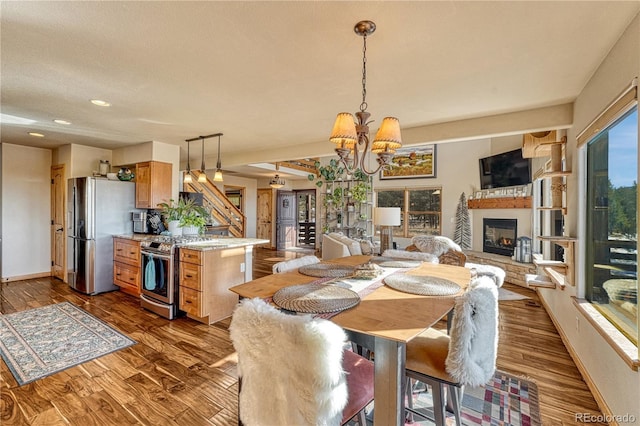 dining space featuring dark wood-type flooring and a notable chandelier