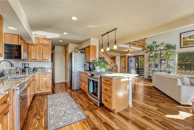 kitchen featuring stainless steel appliances, dark hardwood / wood-style flooring, light stone countertops, a textured ceiling, and sink