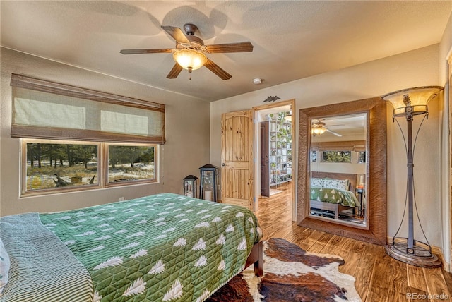 bedroom featuring ceiling fan and hardwood / wood-style flooring