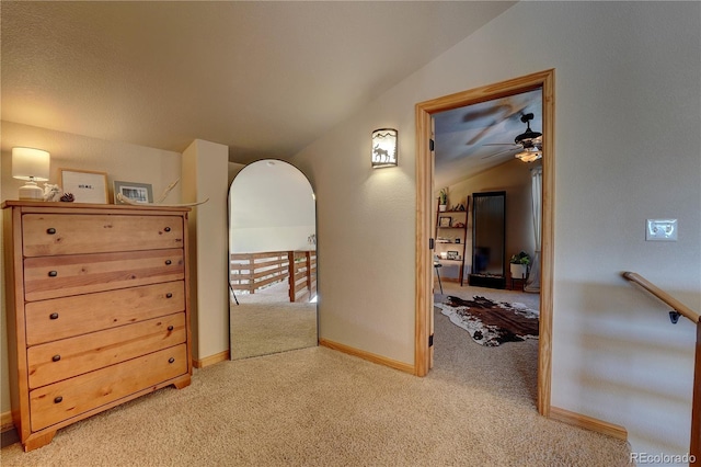 hallway with lofted ceiling and carpet floors