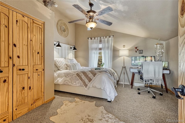 carpeted bedroom with a textured ceiling, ceiling fan, and lofted ceiling