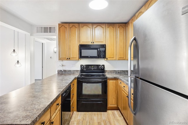3663 S Sheridan Blvd Unit H15, Denver, CO 80235 - kitchen featuring black appliances, a peninsula, dark countertops, and light wood finished floors
