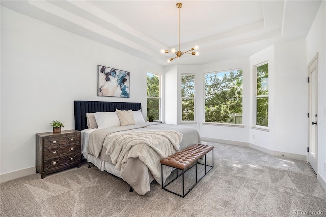 7410 Winter Berry Ln, Castle Pines, CO 80108 - bedroom featuring a tray ceiling, light carpet, and a chandelier