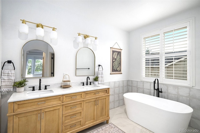 7410 Winter Berry Ln, Castle Pines, CO 80108 - full bathroom with double vanity, a freestanding tub, and tile walls