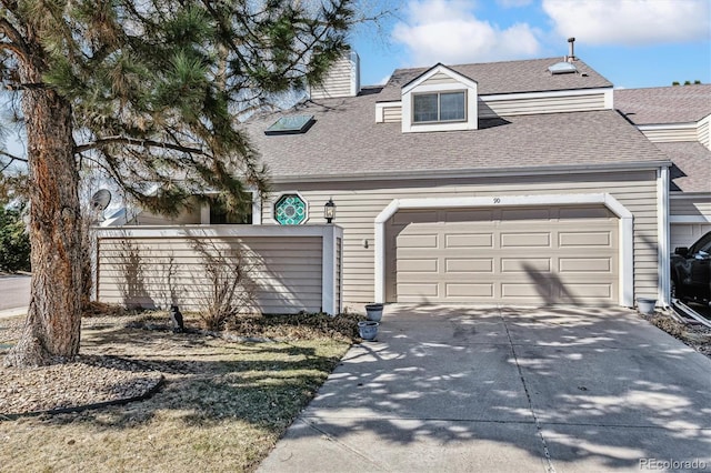 view of front of house featuring a garage, concrete driveway, roof with shingles, and a chimney