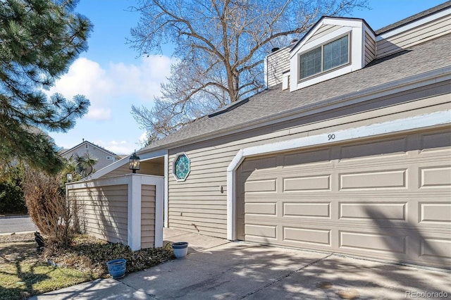 garage featuring concrete driveway