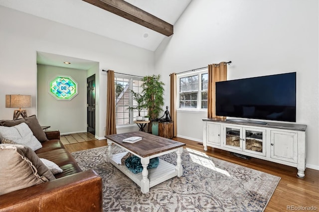 living area with baseboards, high vaulted ceiling, beam ceiling, and wood finished floors