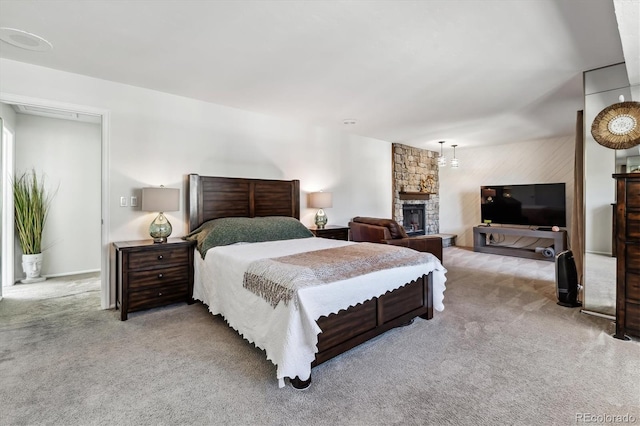 bedroom with carpet and a fireplace