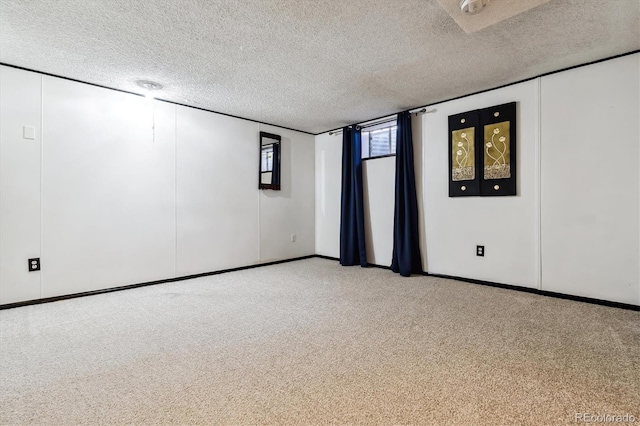 carpeted spare room with a textured ceiling