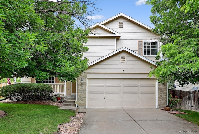 5337 S Ukraine Way, Aurora, CO 80015 - view of front facade featuring a garage, driveway, a porch, and brick siding