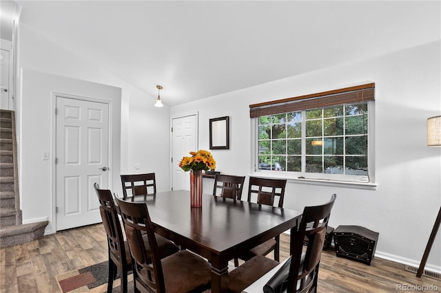 5337 S Ukraine Way, Aurora, CO 80015 - dining space featuring stairs, wood finished floors, and vaulted ceiling