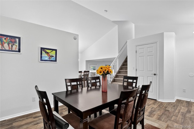 5337 S Ukraine Way, Aurora, CO 80015 - dining space featuring lofted ceiling, wood finished floors, and stairway